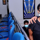 An American woman wearing a Black t-shirt, glasses and a surgical mask looks into the camera after being examined at the Indonesian Immigration office in Denpasar, Bali, Indonesia.